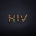 Napis HIV ułożony ze złotych tabletek